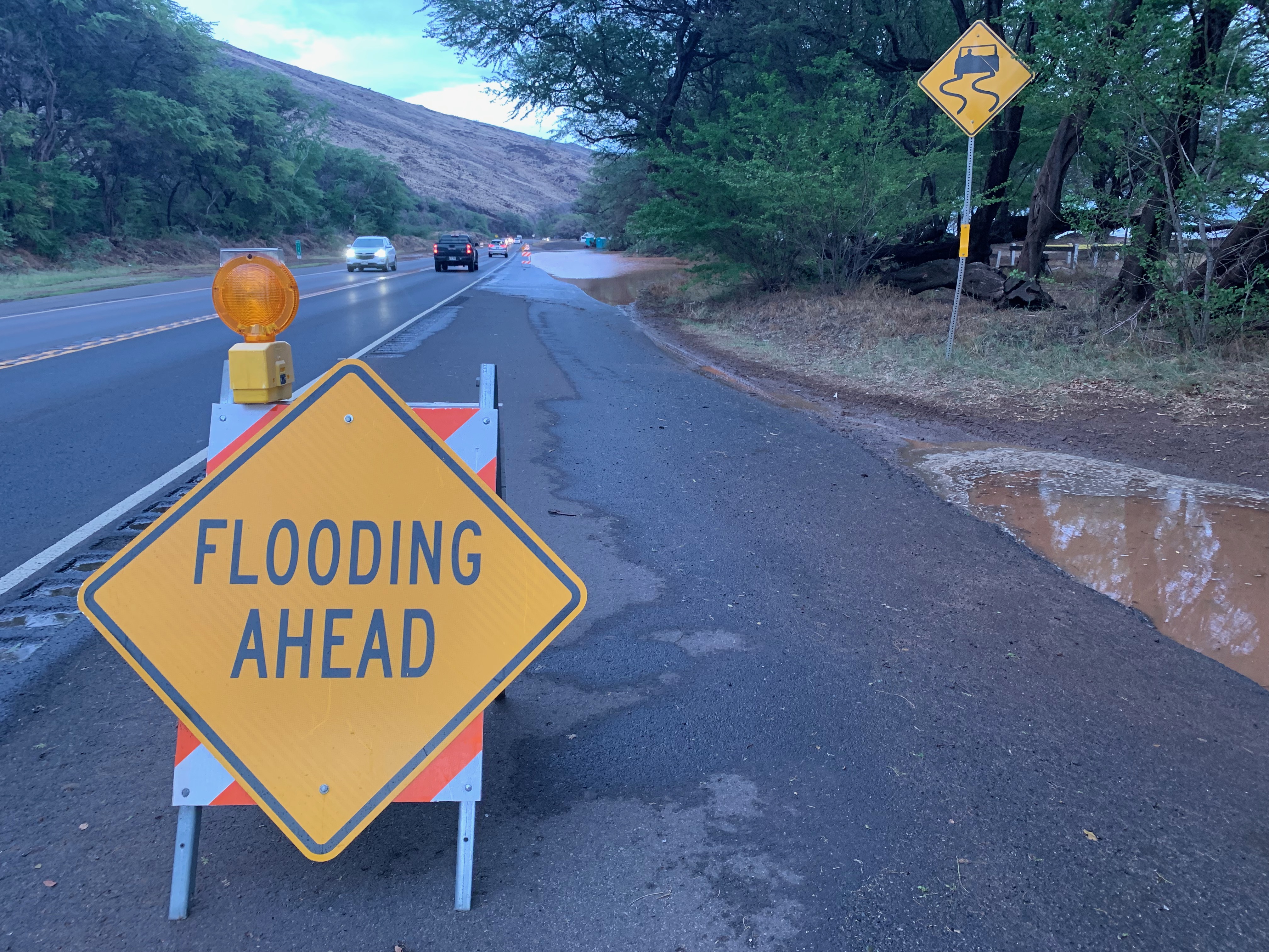 Flooding ahead sign in the road.
